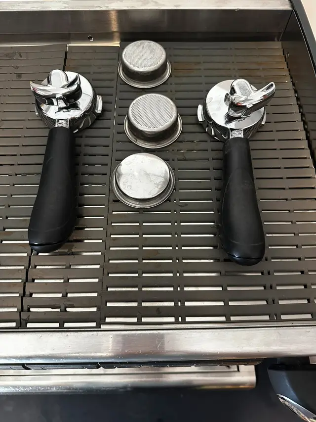Both portafilters with their filter baskets